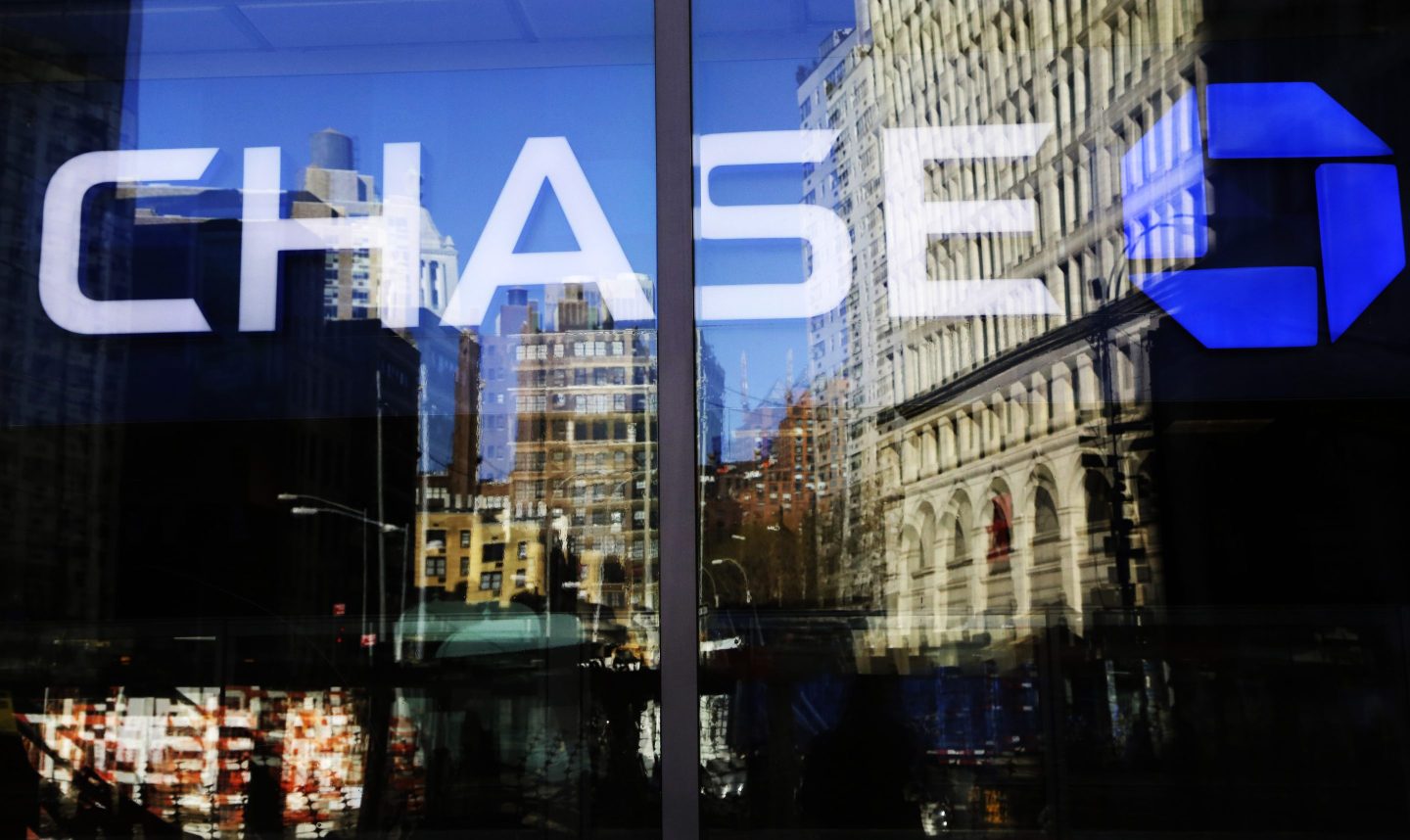 FILE - A Chase bank branch is seen through glass on Jan. 11, 2016, in New York. An unexplained outage at Chase Bank Tuesday, July 25, 2023, has led to interruptions for users of the Zelle payment network, who took to social media to complain. (AP Photo/Mark Lennihan, File)