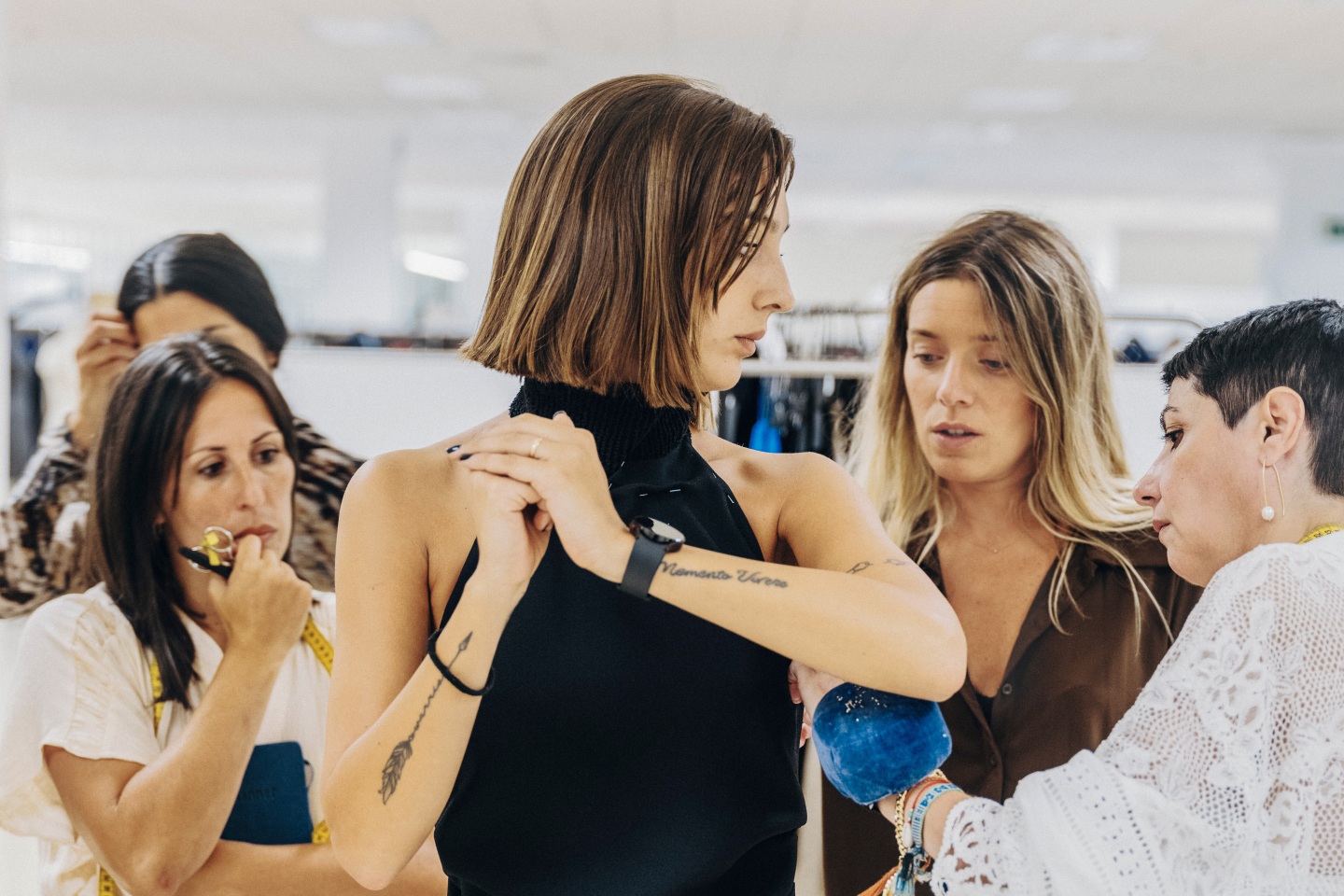 Inditex employees perform a fitting session with a model.