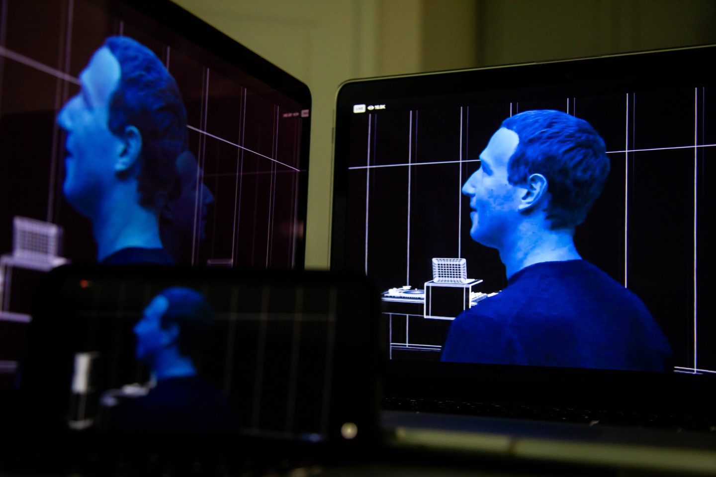 Computer screens depicting Mark Zuckerberg