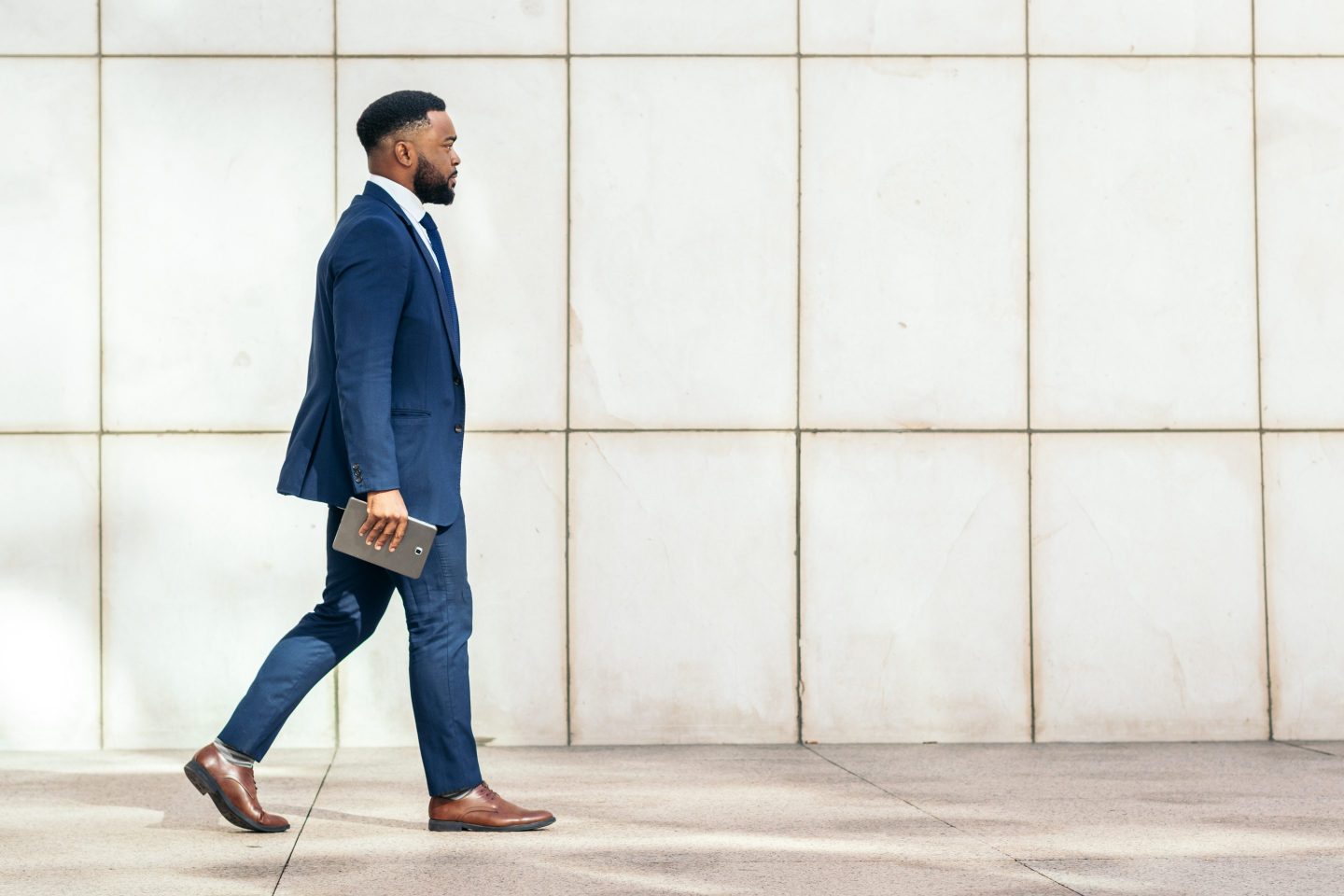 Black businessman in a suit a on his way to the office.