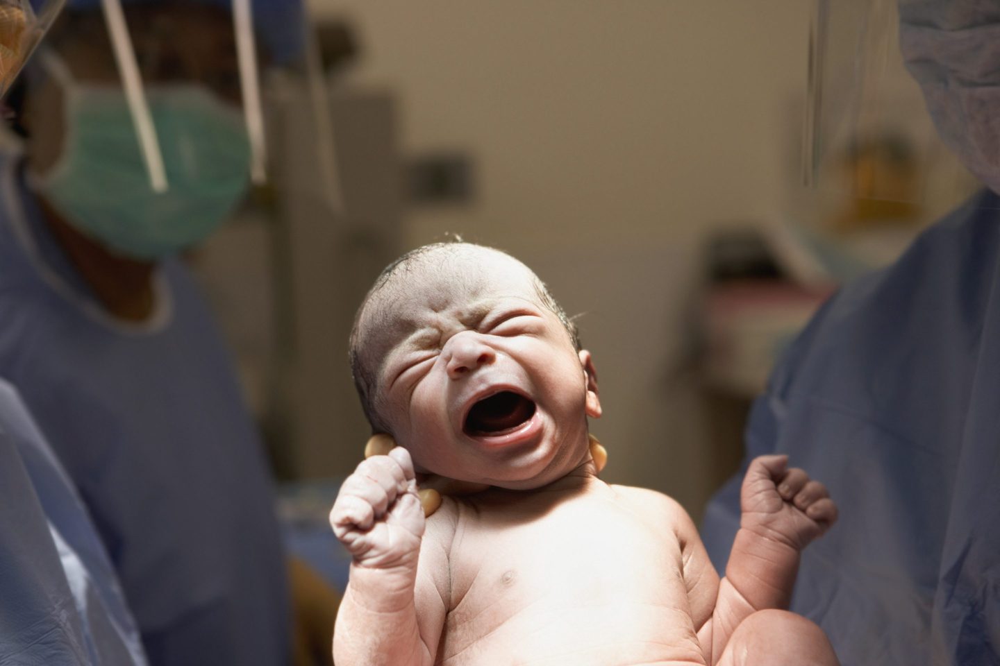 Newborn baby crying in operating room