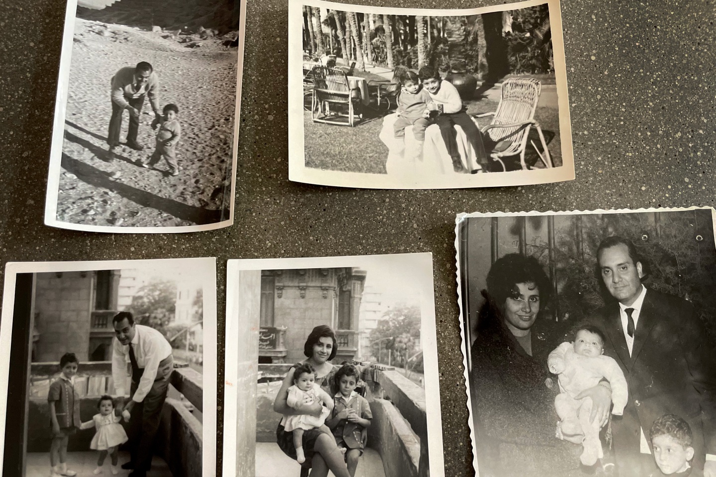 Several black and white photos spread out on a table
