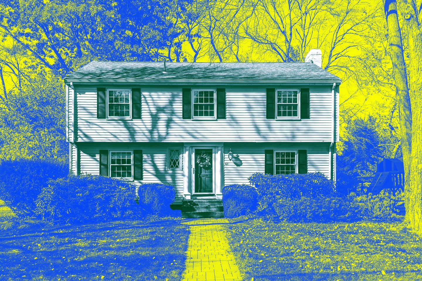 Photo of a two story house surrounded by a front yard and trees that's been treated with yellow and blue colors.