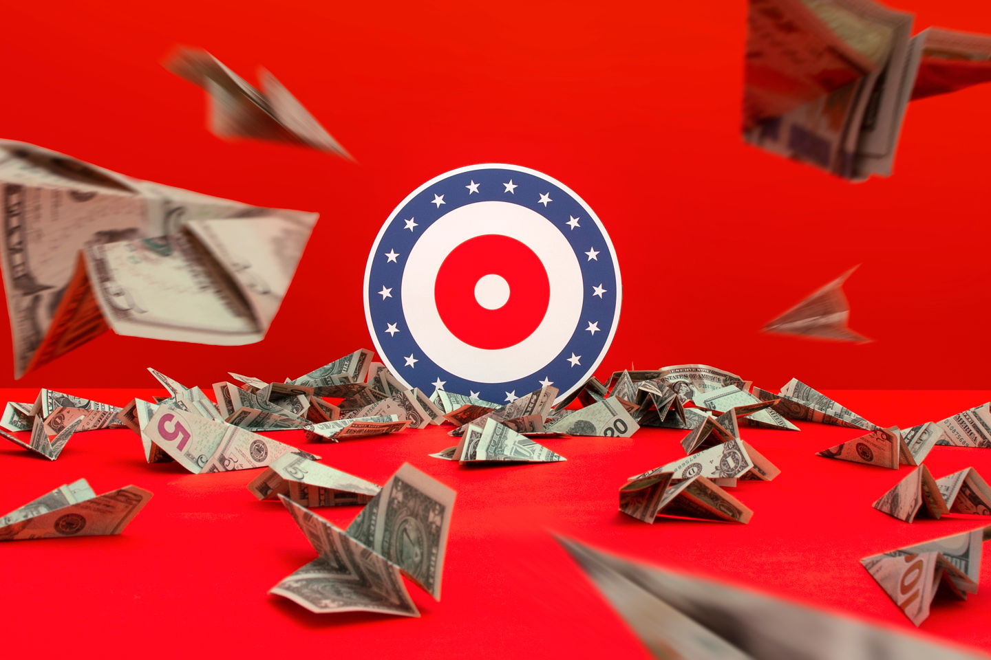 Dollar bills being folded into paper airplanes and thrown at a target.